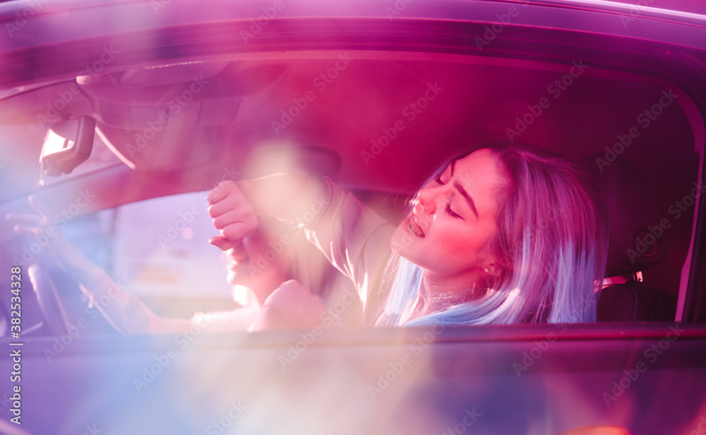 Young women singing along to music in their car Young women singing along to music in their car