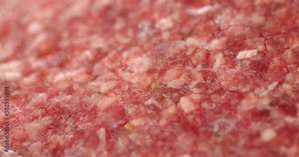 Raw burger meat slowly rotates. Macro background. Raw burger meat slowly rotates. Macro background.
