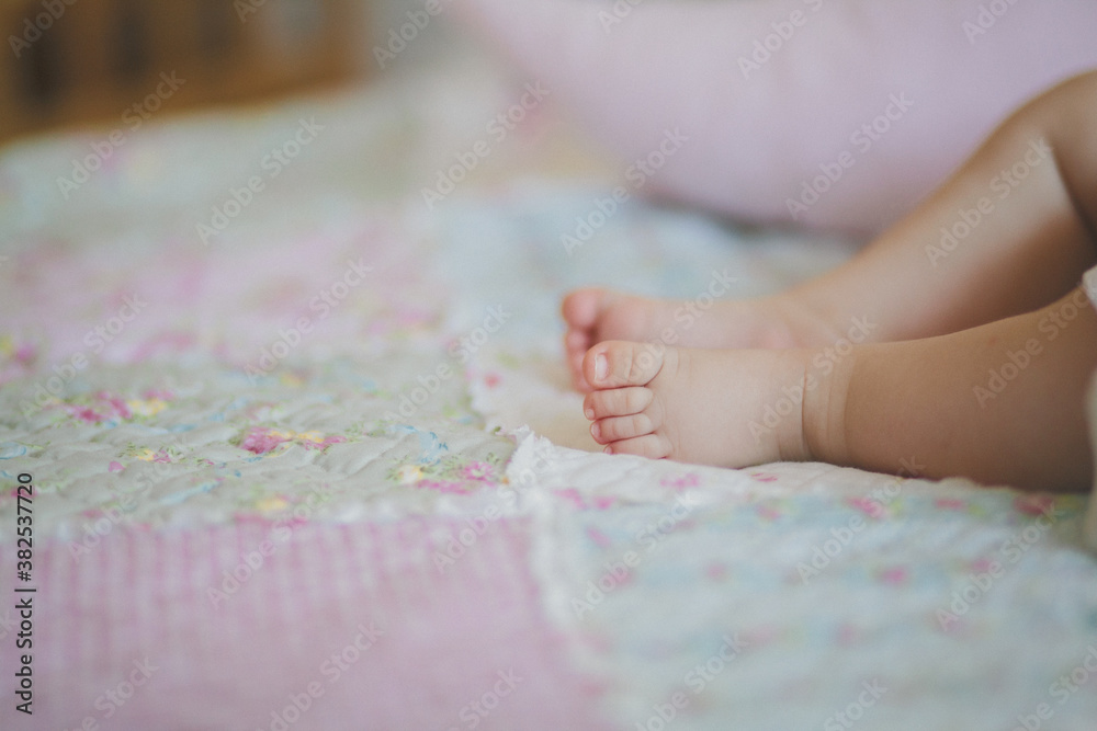 Tiny little baby feet on floral bed Tiny little baby feet on floral bed