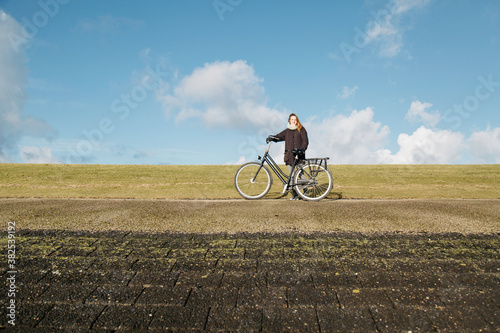 Young having a break to enjoy the sun on a dyke. photo