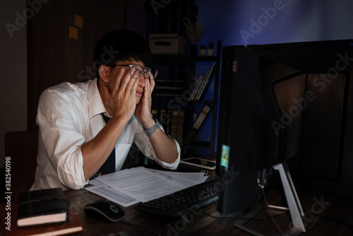 Canvas Print Businessman workaholic sit at the computer working late at night yawn tired and sleeping in the office,Hard work in the later time concept