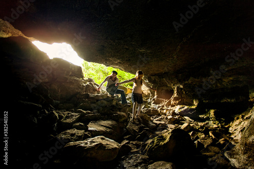 Woman and Little Girl Exploring A Natural Limestone Cave