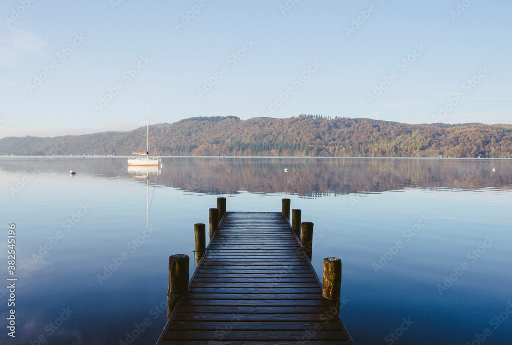 Calm reflections at sunrise on Lake Windermere. Calm reflections at sunrise on Lake Windermere.