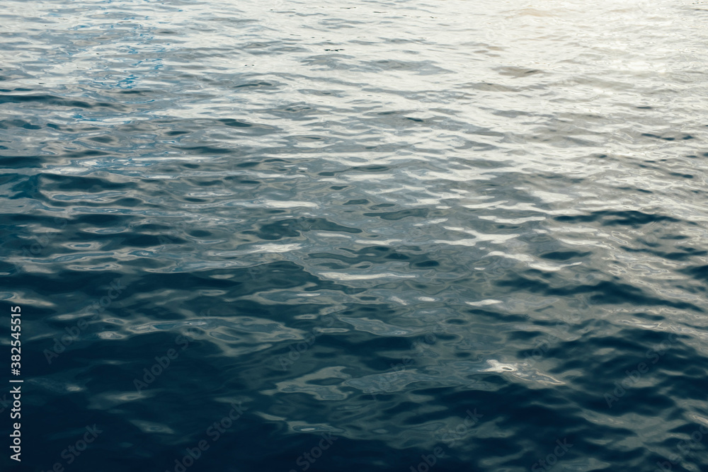Small raindrops and reflections on ocean water Small raindrops and reflections on ocean water