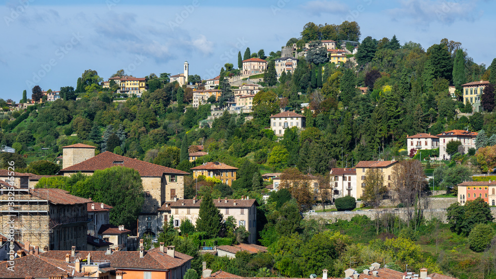 Bergamo, Italy. View of the hills that surround the old town of Bergamo. Homes surrounded by greenery. City green contest. View of San Viglio hill