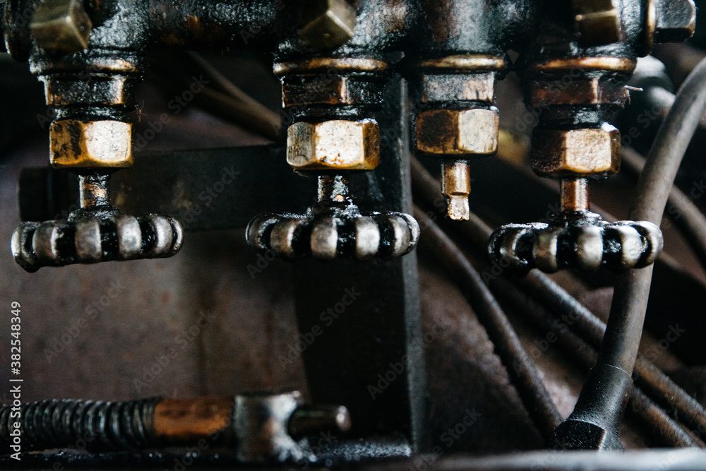 Greasy valves in the engine room of a steam engine