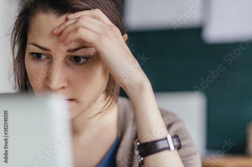 Pensive Young Woman Working in Office