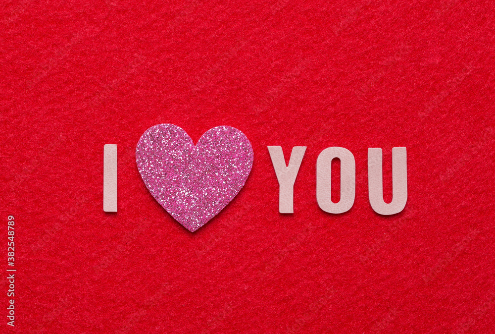 Fototapeta premium Message I love you spelled in leather alphabet and pink glitter heart with copy space.