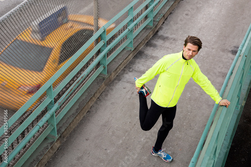 Male runner stretching by the FDR in NYC photo