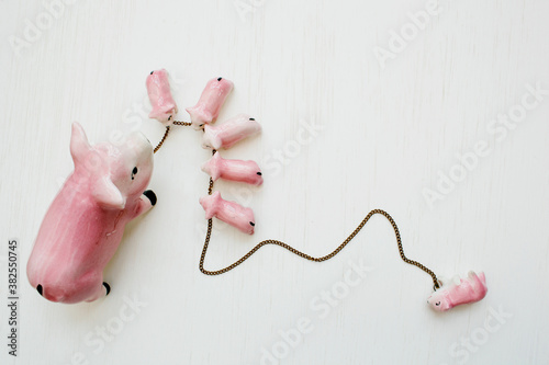 vintage porcelain pig family on a chain photo