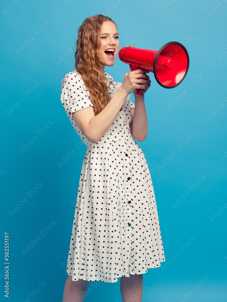 Beautiful girl holds the red megaphone in hand Beautiful girl holds the red megaphone in hand