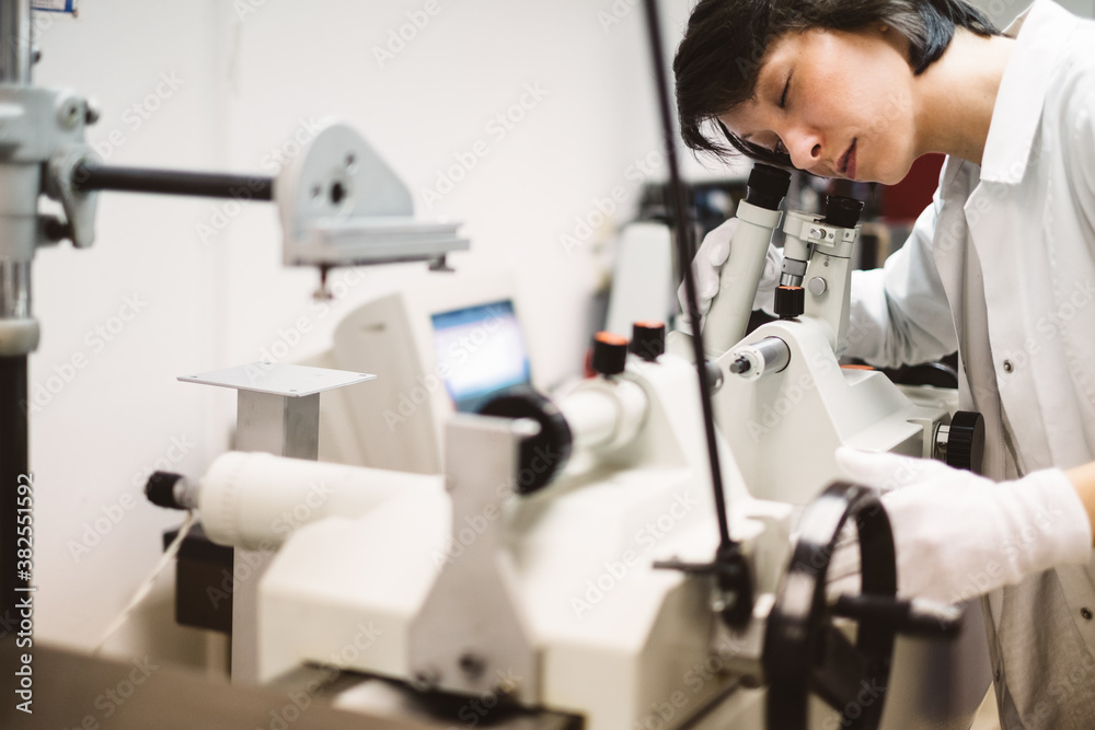 Female Scientist Looking Through the Microscope Female Scientist Looking Through the Microscope