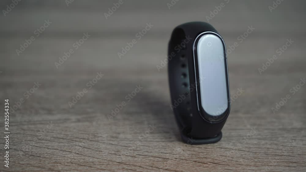 black sports watch is lying on a wooden table black sports watch is lying on a wooden table