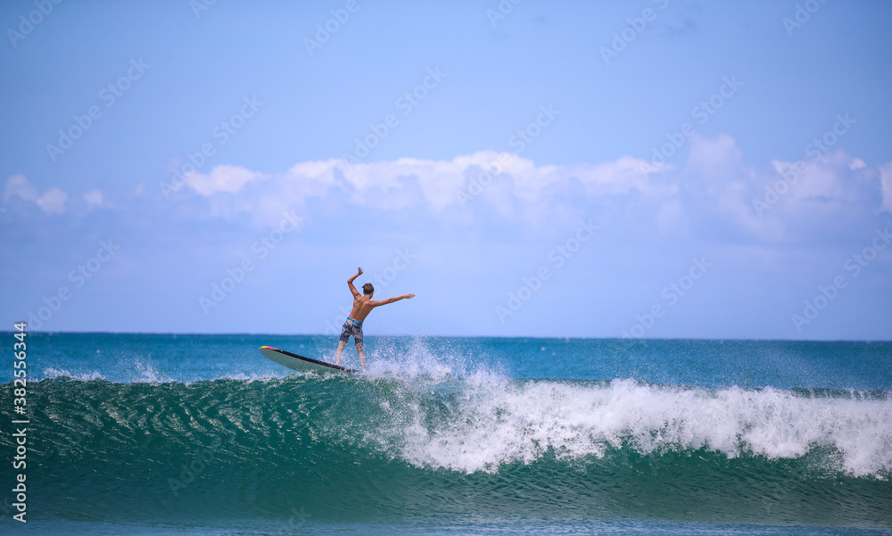 Surfing at Hanalei Beach, Kauai, Hawaii Surfing at Hanalei Beach, Kauai, Hawaii