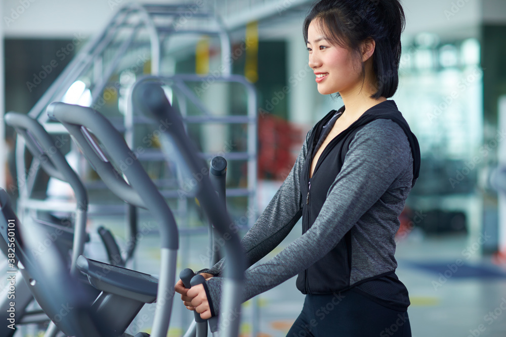 young asian woman running in gym young asian woman running in gym