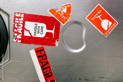 Close up of a well-worn and used hard case luggage with lots of fragile stickers on it