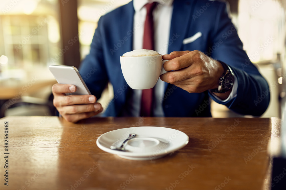 Close-up of businessman having cup of coffee in a cafe.