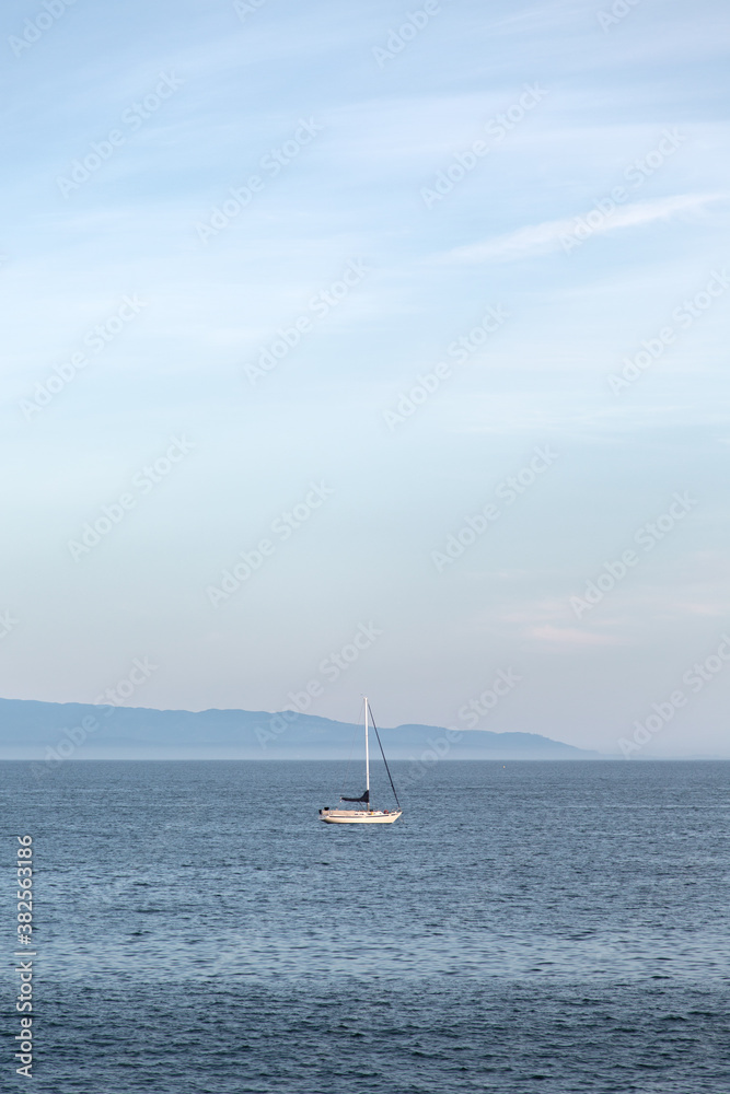 Sail boat floating in the ocean Sail boat floating in the ocean
