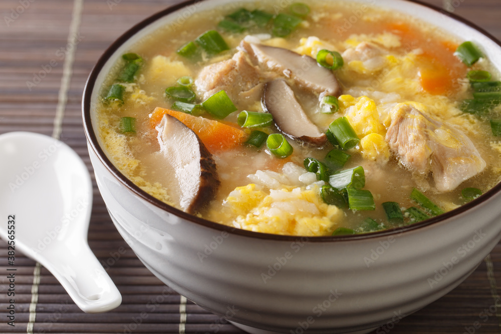 Japanese food, rice and hot pot soup calls Zosui close-up in a bowl. Horizontal
