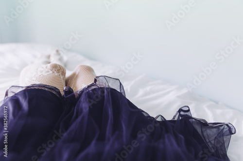 Legs of woman wearing purple tulle skirt photo