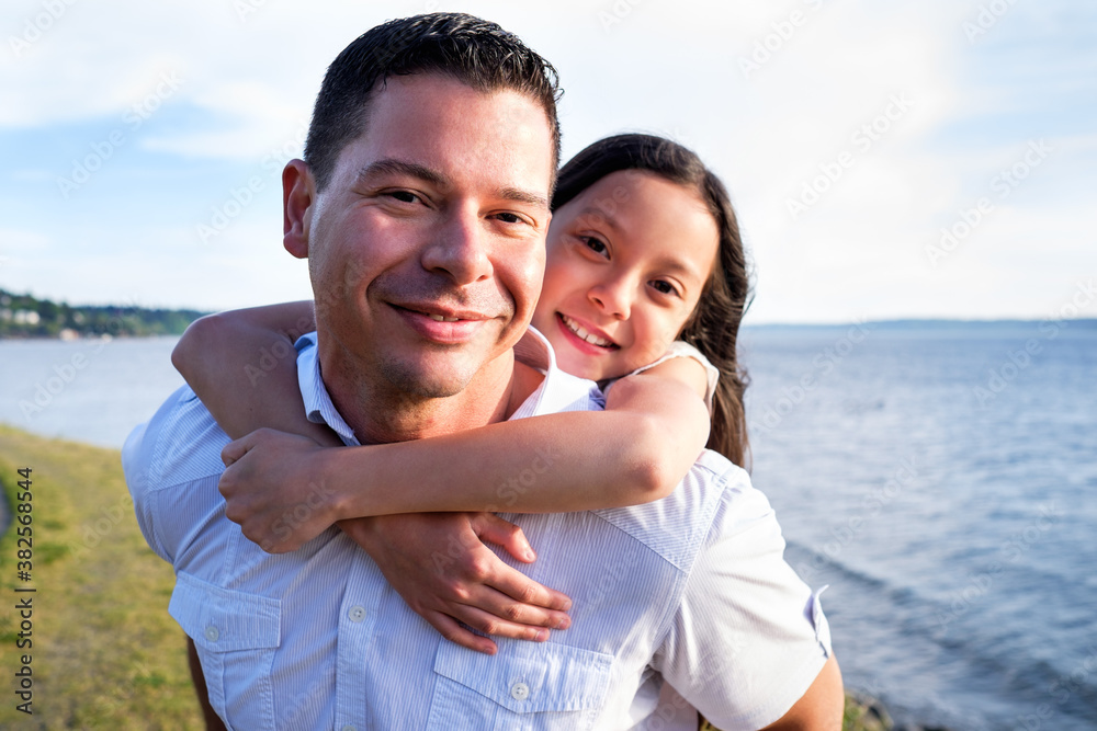 Happy Hispanic father and daughter having fun together on the beach Happy Hispanic father and daughter having fun together on the beach