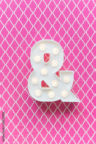 Ampersand marquee light on a pink background photo