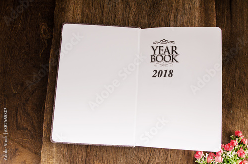 education book on wooden table and backgroun din light vintage tone 2018