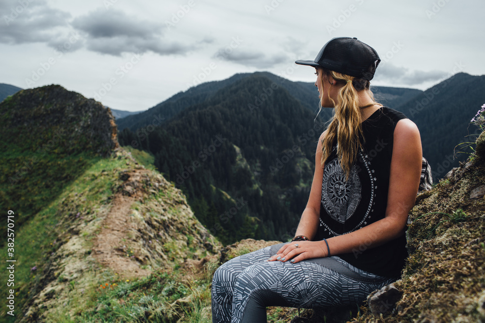 Woman Hiker Sitting on Mountain Cliff Woman Hiker Sitting on Mountain Cliff