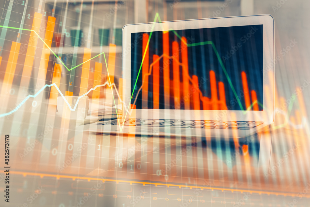 Forex market chart hologram and personal computer background. Multi exposure. Concept of investment. Forex market chart hologram and personal computer background. Multi exposure. Concept of investment.