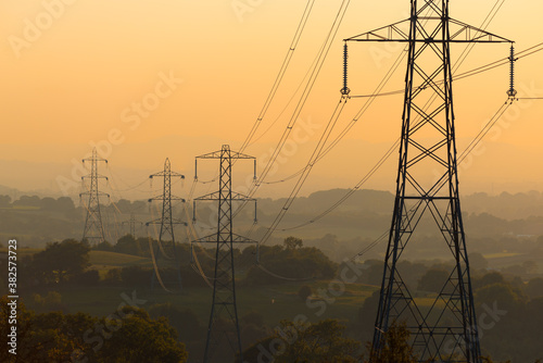 Power Lines in rural land at Sunset