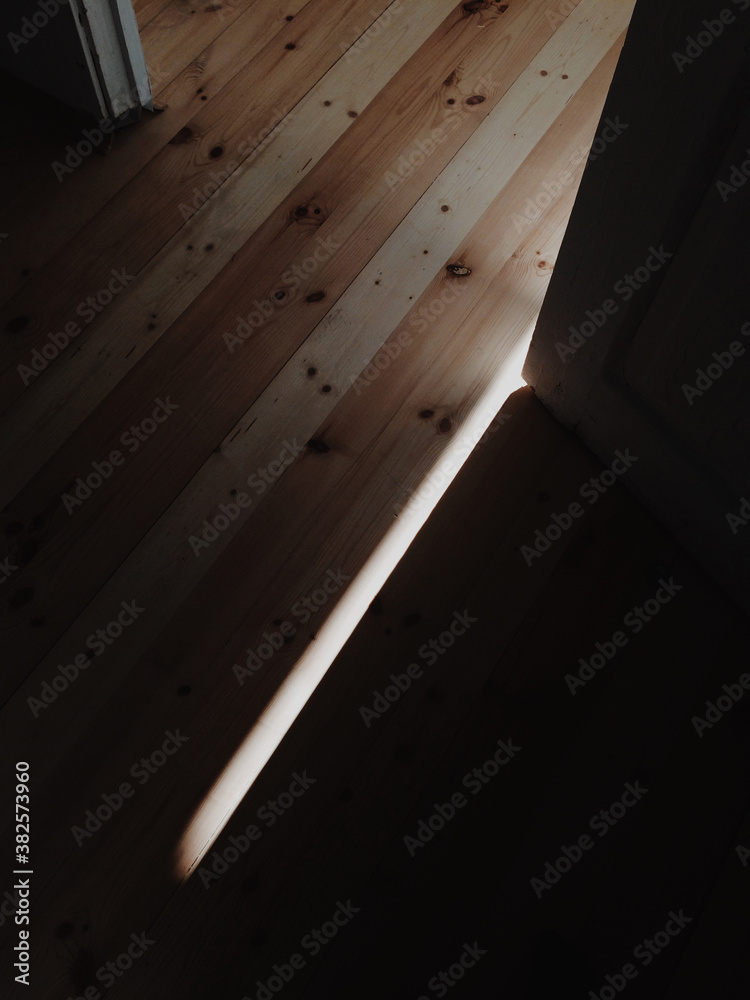 Ray of light on wooden floor Ray of light on wooden floor