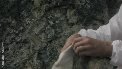 The doctor puts on the right rubber glove