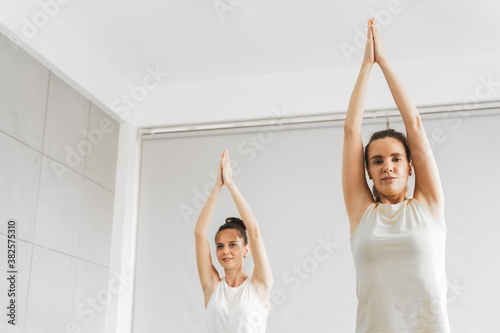 Two caucacian woman doing yoga in gym or studio, Middle age female workout exercise at home photo