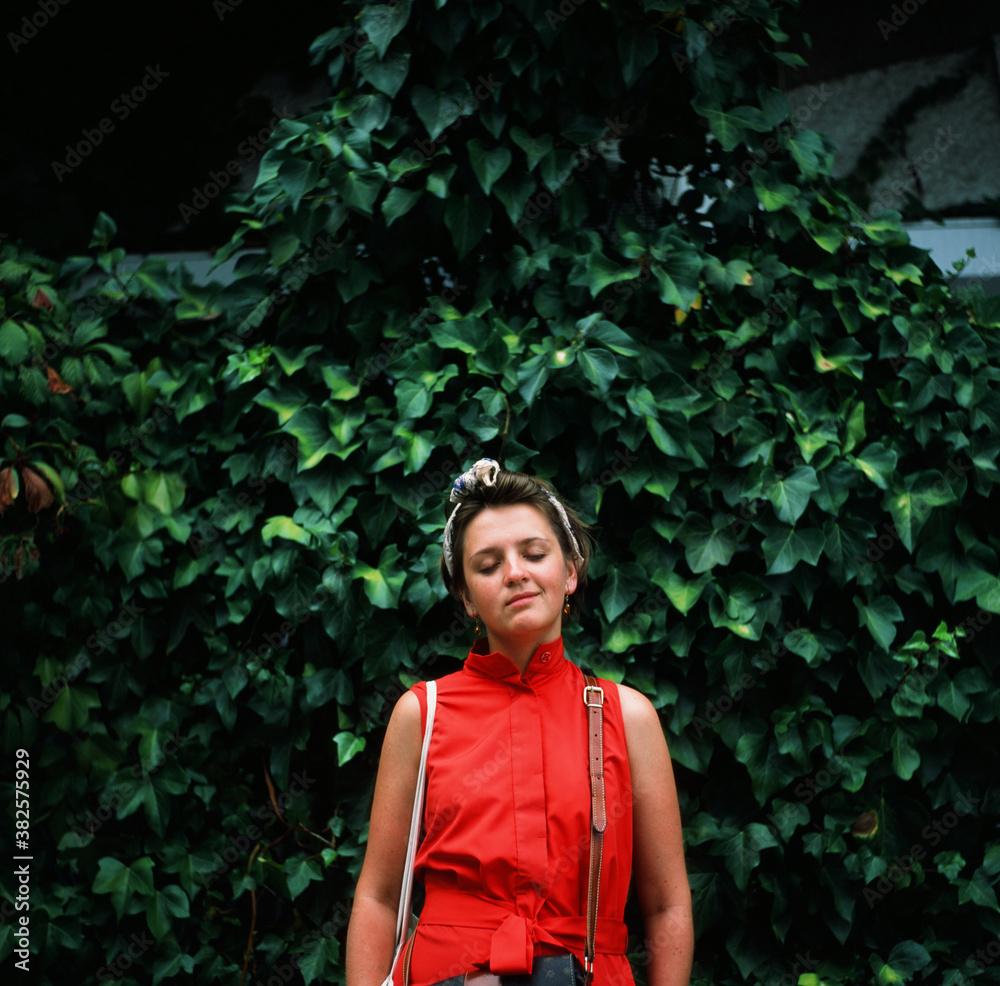 The film portrait of a young smiling woman in red dress The film portrait of a young smiling woman in red dress