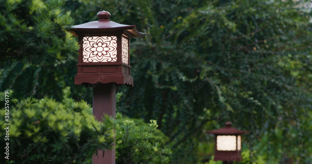 Wooden street lamp in the garden