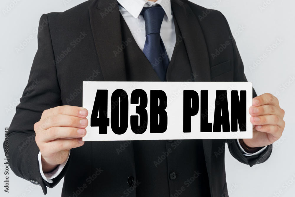 A businessman holds a sign in his hands which says 403B PLAN A businessman holds a sign in his hands which says 403B PLAN