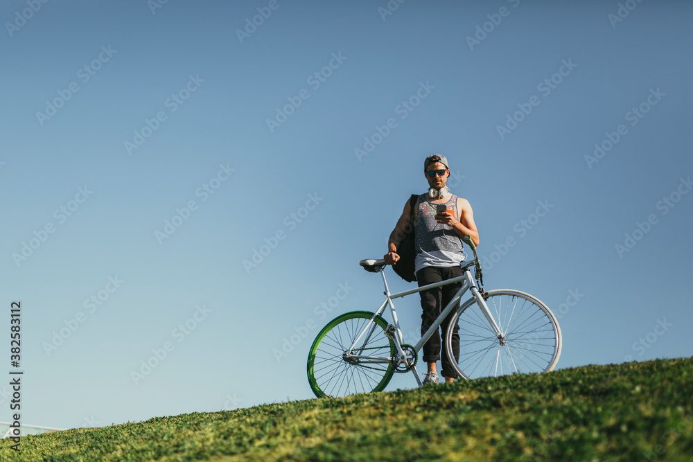 Youn Man Using a Phone o Top of a Hill Youn Man Using a Phone o Top of a Hill