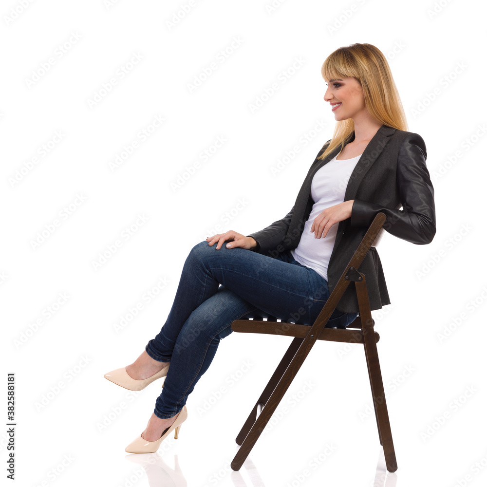 Happy Businesswoman Is Sitting On A Chair. Side View.