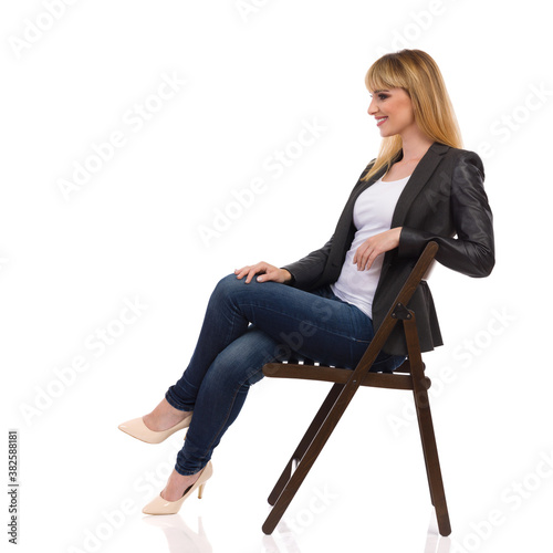 Happy Businesswoman Is Sitting On A Chair. Side View. © studioloco