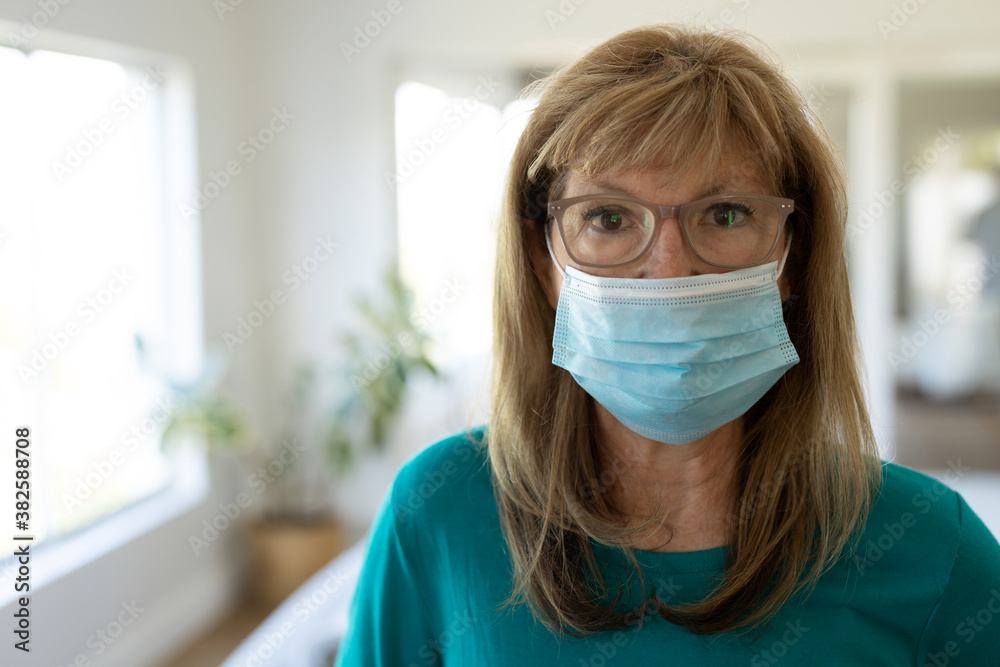 Portrait of senior woman wearing face mask at home Portrait of senior woman wearing face mask at home