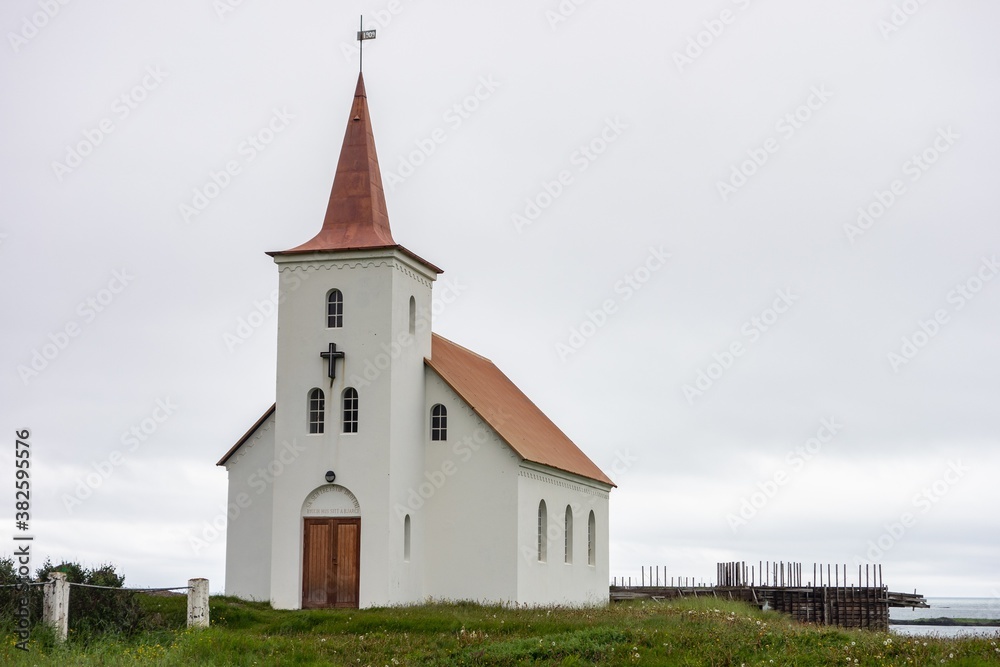White Kollafjardarneskirkja Christian church at Western Iceland in cloudy weather