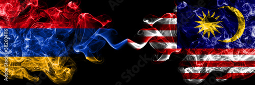 Armenia vs Malaysia, Malaysian smoky mystic flags placed side by side. Thick colored silky abstract smoke flags