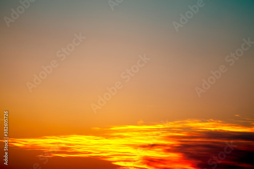Sky at sunset with bright orange clouds