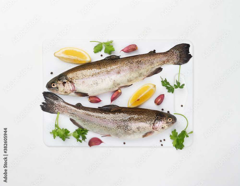 Two raw trouts with spices and lemon Two raw trouts with spices and lemon