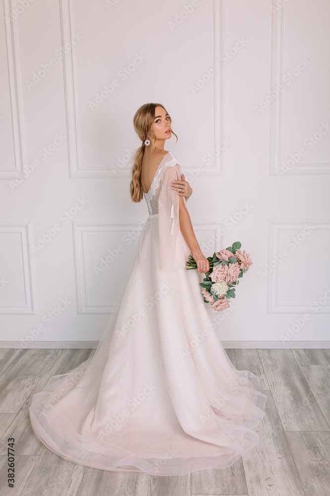 young woman in a white wedding dress with long hair before the engagement ceremony with a bouquet of flowers on a white background with a model appearance important wife for the bride
young woman in a white wedding dress with long hair before the engagement ceremony with a bouquet of flowers on a white background with a model appearance important wife for the bride