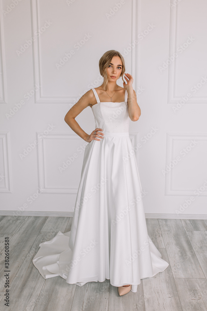 young woman in a white wedding dress with long hair before the engagement ceremony on a white background with a model appearance important wife for the bride posing in front of the photographer
young woman in a white wedding dress with long hair before the engagement ceremony on a white background with a model appearance important wife for the bride posing in front of the photographer