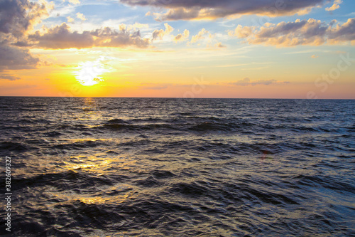 Sunset over the coast of Lake Michigan on a beach in the Great Lakes State. 