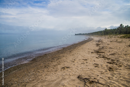 Fog rolls into the shore of a lake on the coast of Lake Huron in Michigan. 