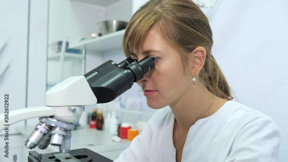 Microbiologist is testing a sample of blood contaminated by Coronavirus Covid-19 Microbiologist is testing a sample of blood contaminated by Coronavirus Covid-19