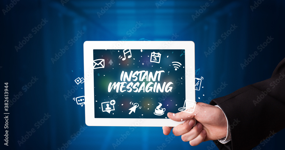 Young business person working on tablet and shows the inscription: INSTANT MESSAGING Young business person working on tablet and shows the inscription: INSTANT MESSAGING